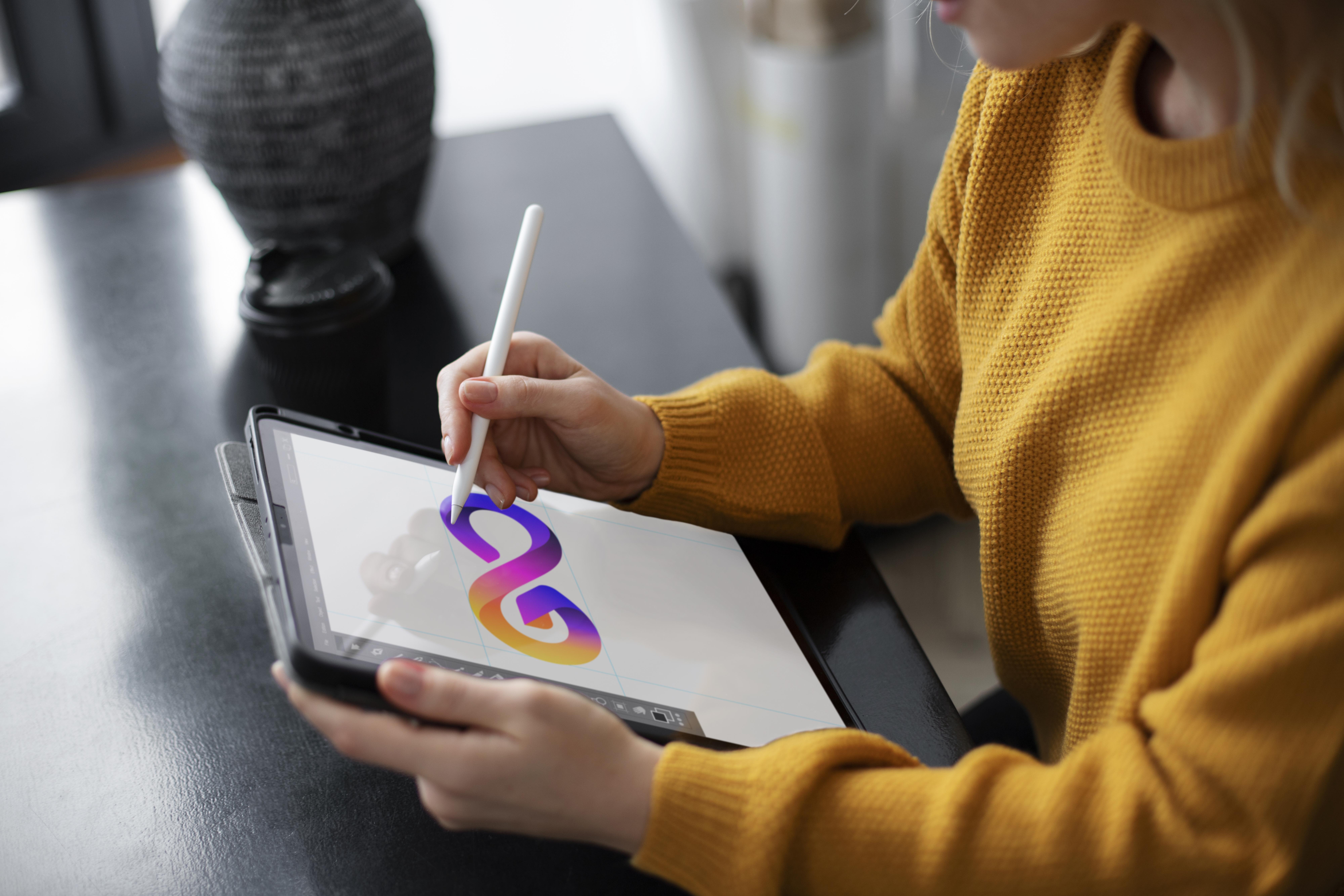 woman creating a logo on her tablet